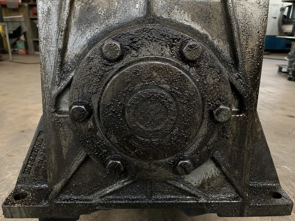 Industrial machine housing before grease removal